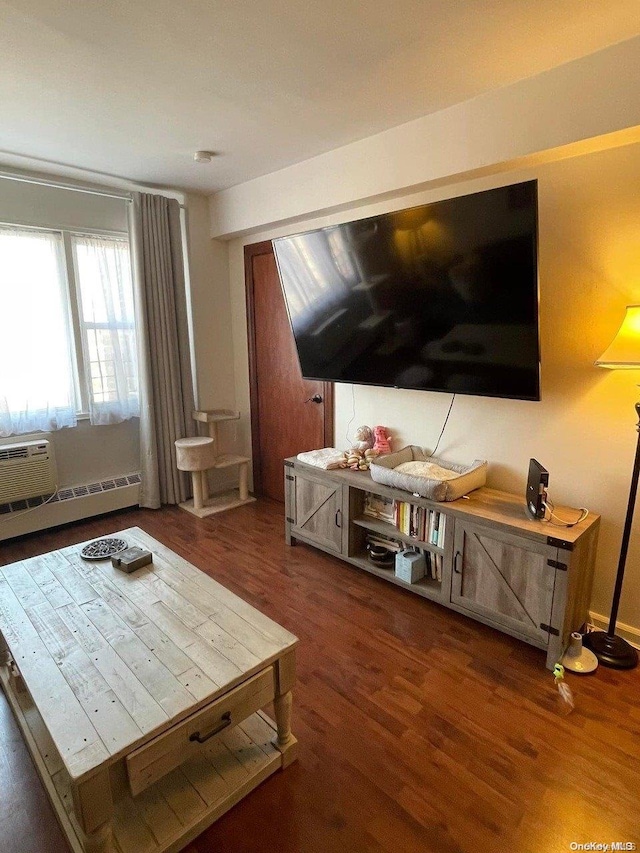 living room featuring dark hardwood / wood-style flooring and a baseboard heating unit