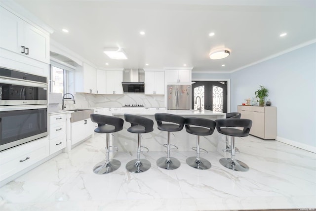 kitchen with sink, a center island, white cabinets, and appliances with stainless steel finishes