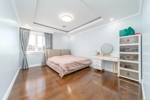 bedroom featuring a raised ceiling, wood-type flooring, and crown molding