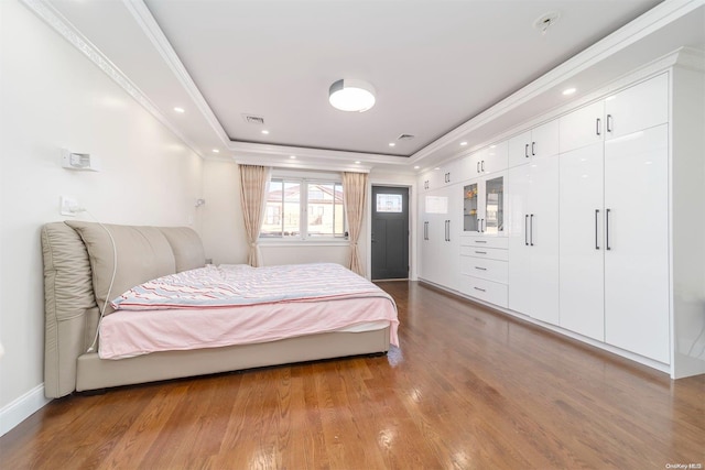 bedroom with light wood-type flooring and ornamental molding