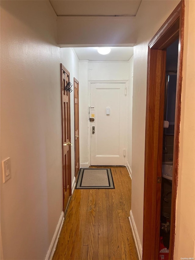 hall with wood-type flooring