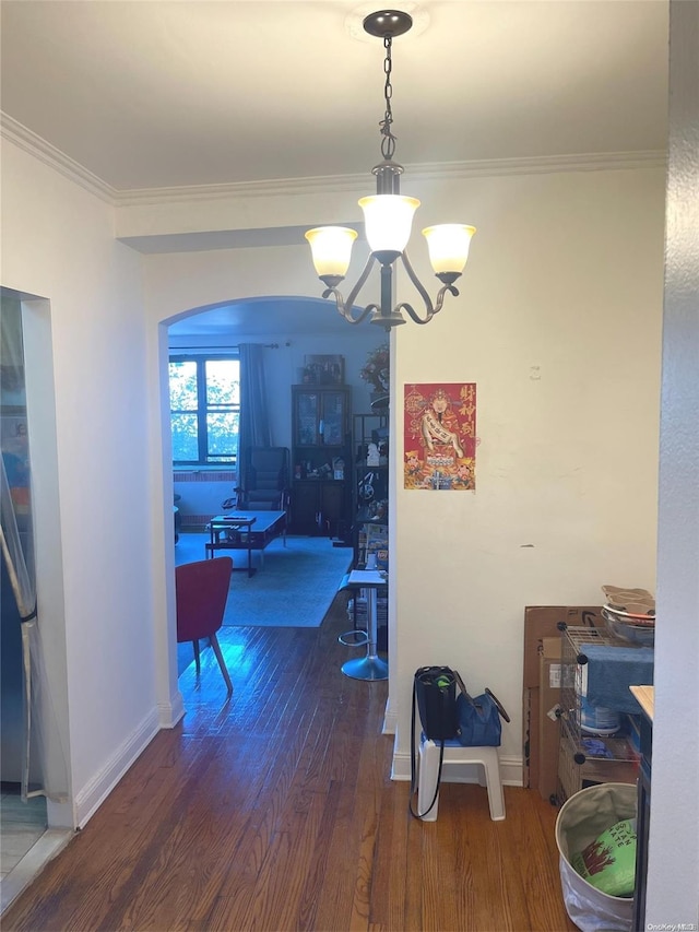 dining room featuring a chandelier, dark hardwood / wood-style floors, and ornamental molding