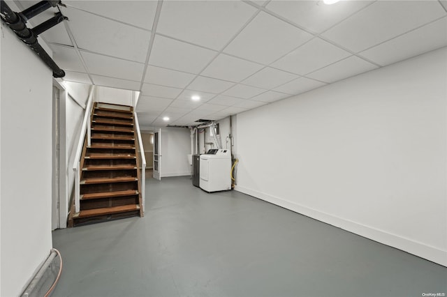 basement with a drop ceiling and washer / dryer