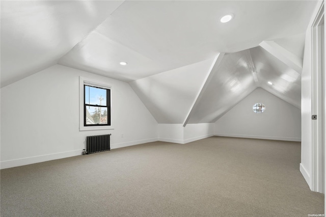 additional living space featuring lofted ceiling, carpet floors, and radiator