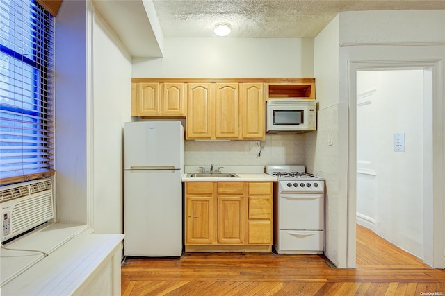 kitchen featuring light brown cabinetry, backsplash, white appliances, sink, and light hardwood / wood-style floors