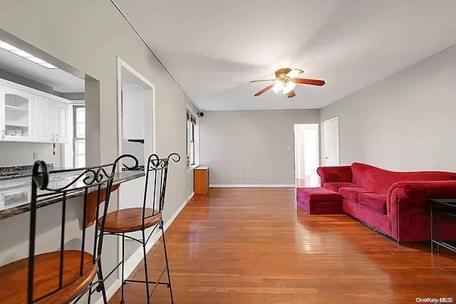 living room with ceiling fan and wood-type flooring