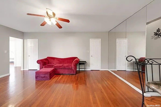 sitting room featuring hardwood / wood-style floors and ceiling fan