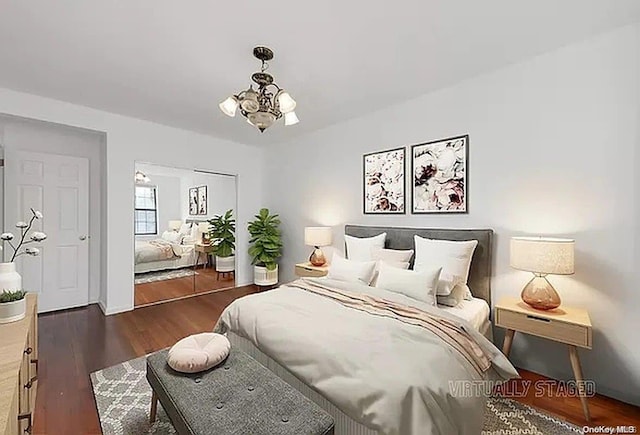 bedroom with dark wood-type flooring and a chandelier