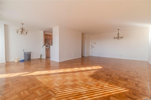 166-25 Powells Cove Blvd Unit 10G, Whitestone, NY 11357 - unfurnished living room featuring a chandelier