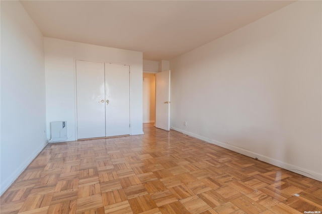 166-25 Powells Cove Blvd Unit 10G, Whitestone, NY 11357 - unfurnished bedroom featuring baseboards and a closet