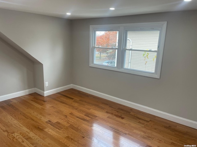 additional living space featuring hardwood / wood-style flooring