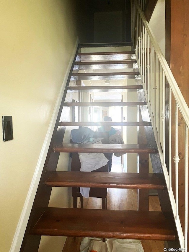 stairway featuring wood-type flooring