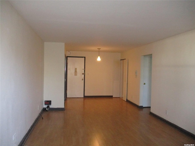 unfurnished room featuring dark wood-type flooring