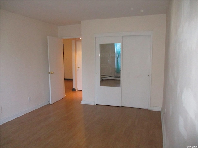 unfurnished room with hardwood / wood-style floors