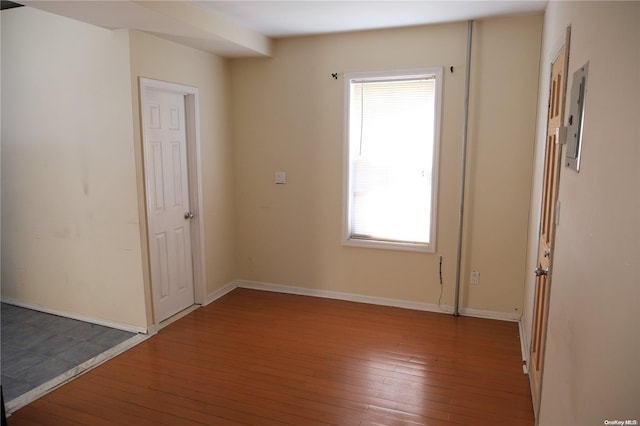 unfurnished room with a healthy amount of sunlight and wood-type flooring