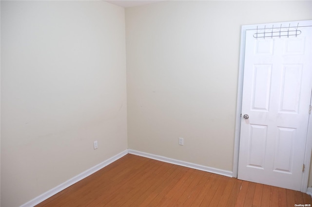 empty room with hardwood / wood-style floors