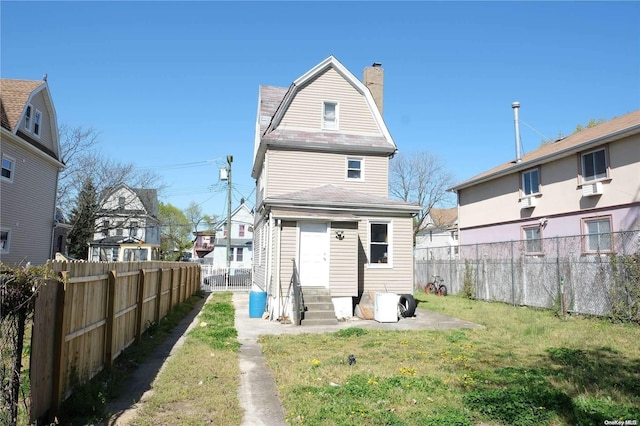 back of property featuring a yard