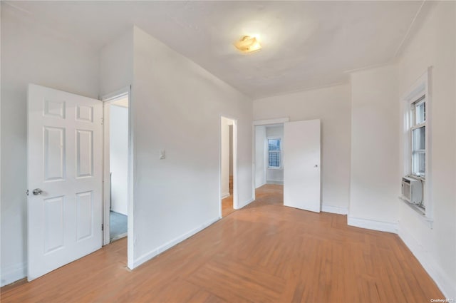 spare room featuring cooling unit and light hardwood / wood-style flooring