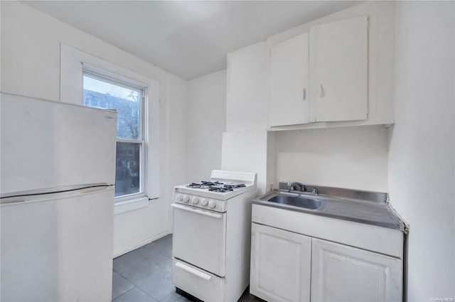 kitchen featuring white cabinets, white appliances, and sink