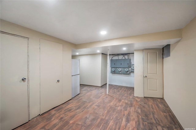 basement featuring white fridge and dark hardwood / wood-style floors