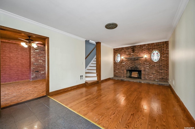 unfurnished living room with ceiling fan, dark hardwood / wood-style flooring, crown molding, and a brick fireplace