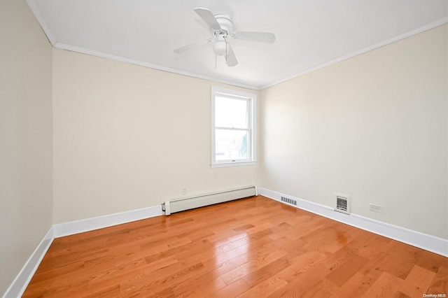 unfurnished room featuring ceiling fan, wood-type flooring, baseboard heating, and ornamental molding