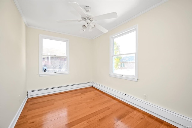 unfurnished room featuring a baseboard radiator, hardwood / wood-style flooring, and a healthy amount of sunlight