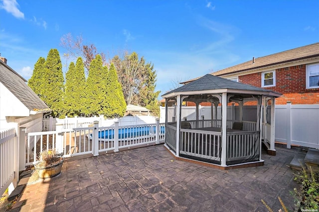 view of patio / terrace featuring a gazebo and a fenced in pool