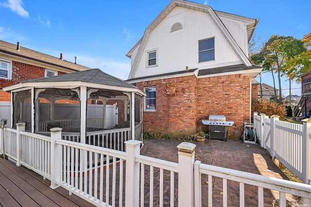 rear view of property featuring a gazebo and a patio