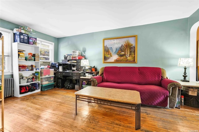 living room featuring light wood-type flooring and radiator heating unit