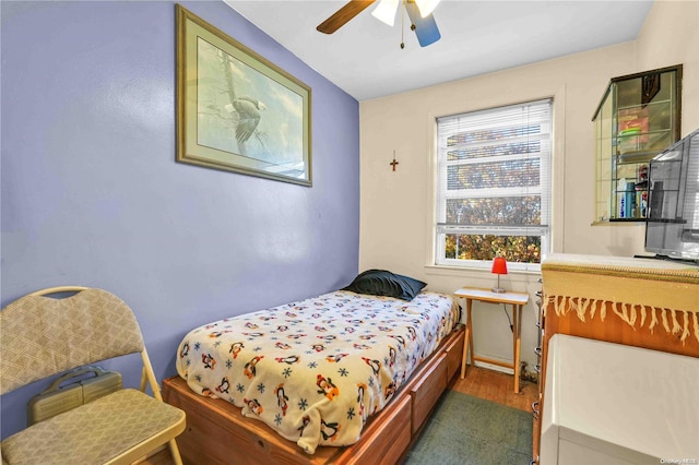 bedroom with ceiling fan and dark hardwood / wood-style floors