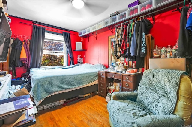 bedroom with wood-type flooring and ceiling fan