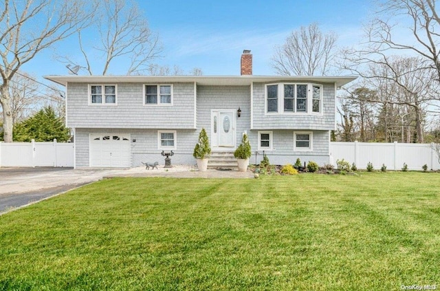 view of front of property featuring a garage and a front lawn