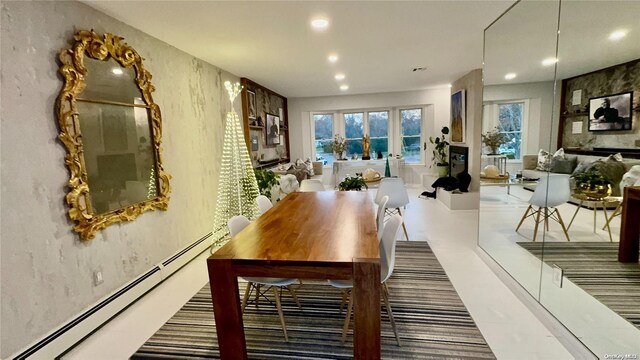 dining space featuring a baseboard heating unit