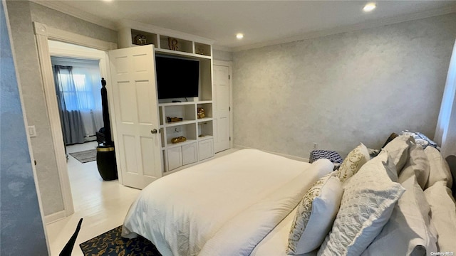 bedroom with light hardwood / wood-style floors and ornamental molding