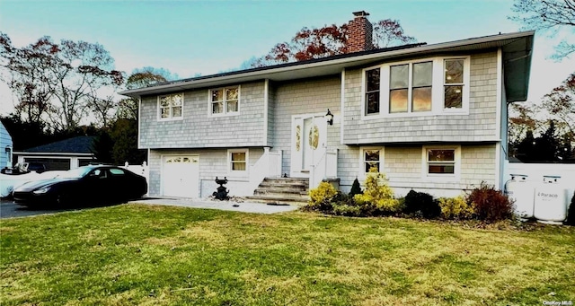 bi-level home with a front yard and a garage