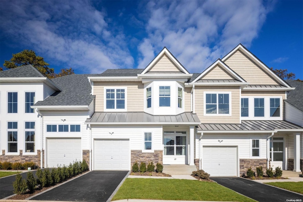 1239 Old Nichols Rd Unit 51, Islandia, NY 11749 - multi unit property with a standing seam roof, driveway, and stone siding