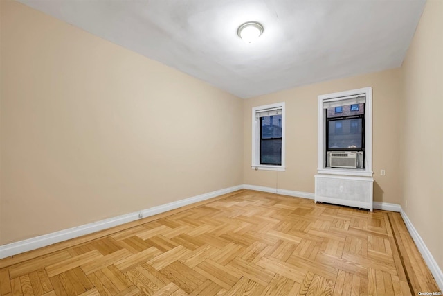 spare room with light parquet floors and cooling unit