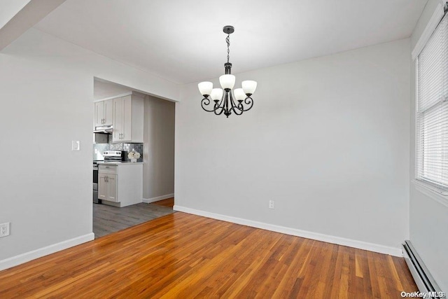 interior space featuring baseboard heating, an inviting chandelier, and hardwood / wood-style floors