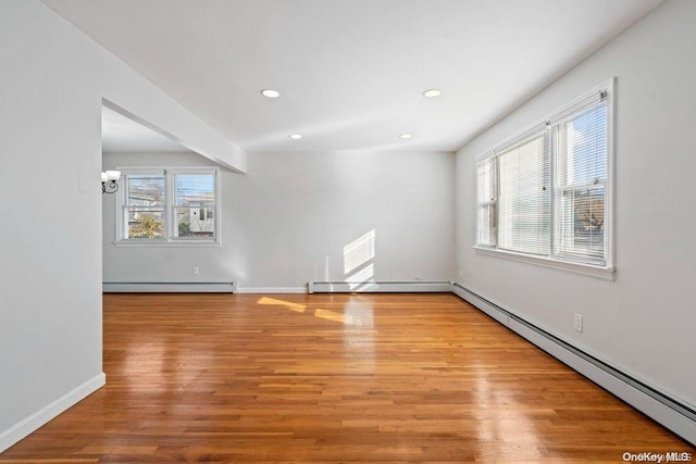 spare room with a healthy amount of sunlight and a baseboard heating unit