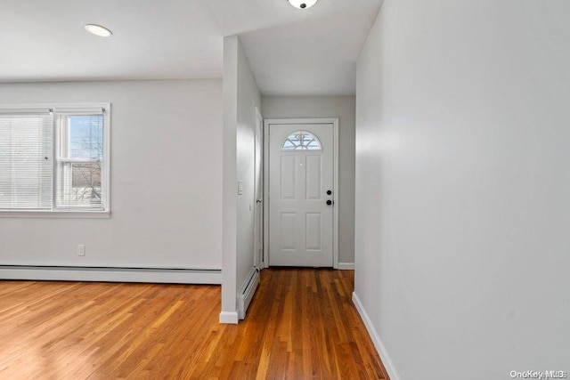 doorway to outside with dark hardwood / wood-style floors and baseboard heating