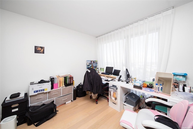 office with light wood-type flooring