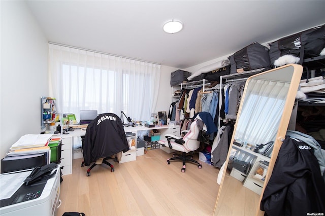 home office with light hardwood / wood-style flooring