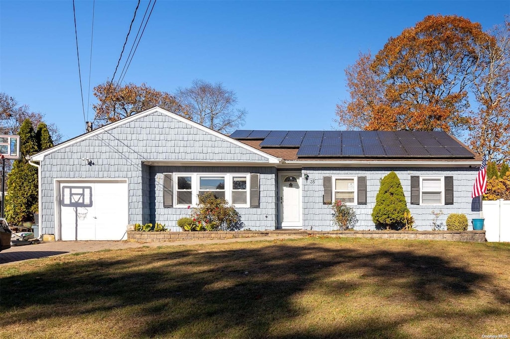 view of front of home with solar panels and a front lawn