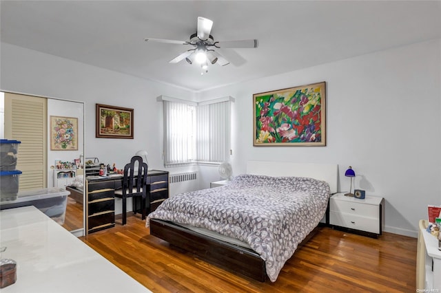 bedroom featuring radiator heating unit, a closet, dark hardwood / wood-style floors, and ceiling fan