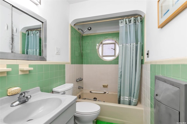 full bathroom featuring toilet, shower / tub combo with curtain, tile walls, and sink