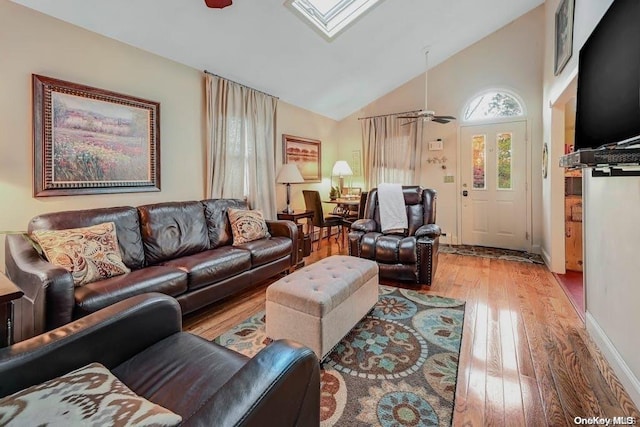 529 Birch Hollow Dr, Shirley, NY 11967 - living room featuring a ceiling fan, wood finished floors, a skylight, and high vaulted ceiling