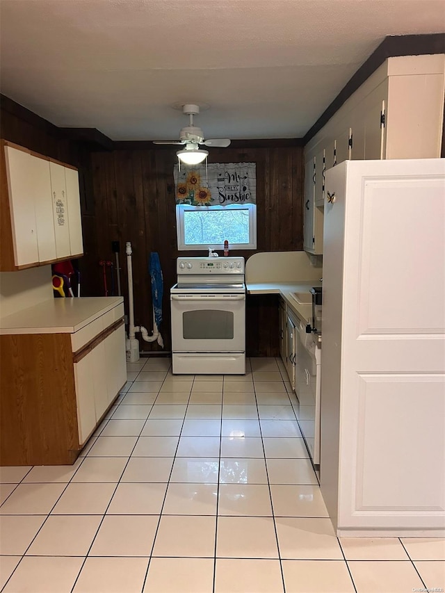 kitchen featuring white cabinetry, ceiling fan, white electric range, wood walls, and light tile patterned flooring