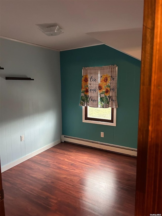 unfurnished room featuring dark wood-type flooring and a baseboard radiator