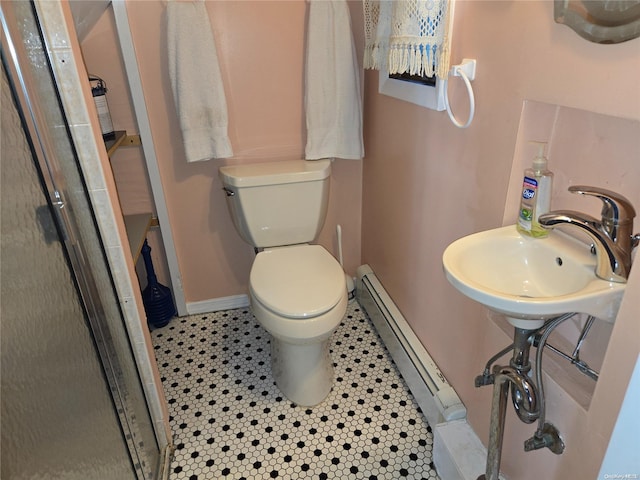 bathroom with a baseboard radiator, tile patterned floors, and toilet